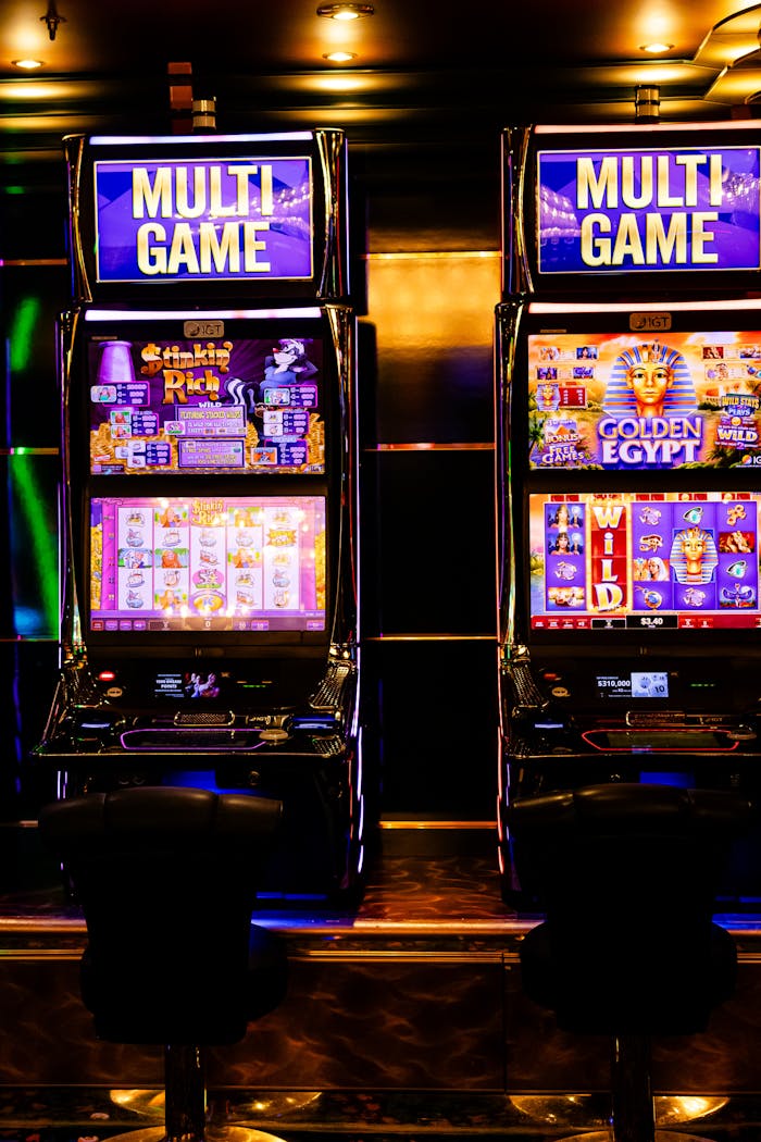contact-img Colorful multi-game slot machines inside a lively casino environment at night.