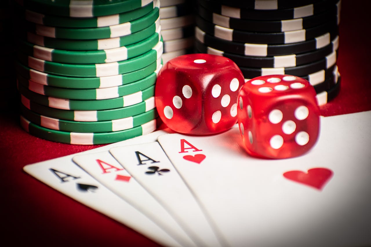 our-experience Close-up of poker hand with dice and chips, symbolizing casino gaming.