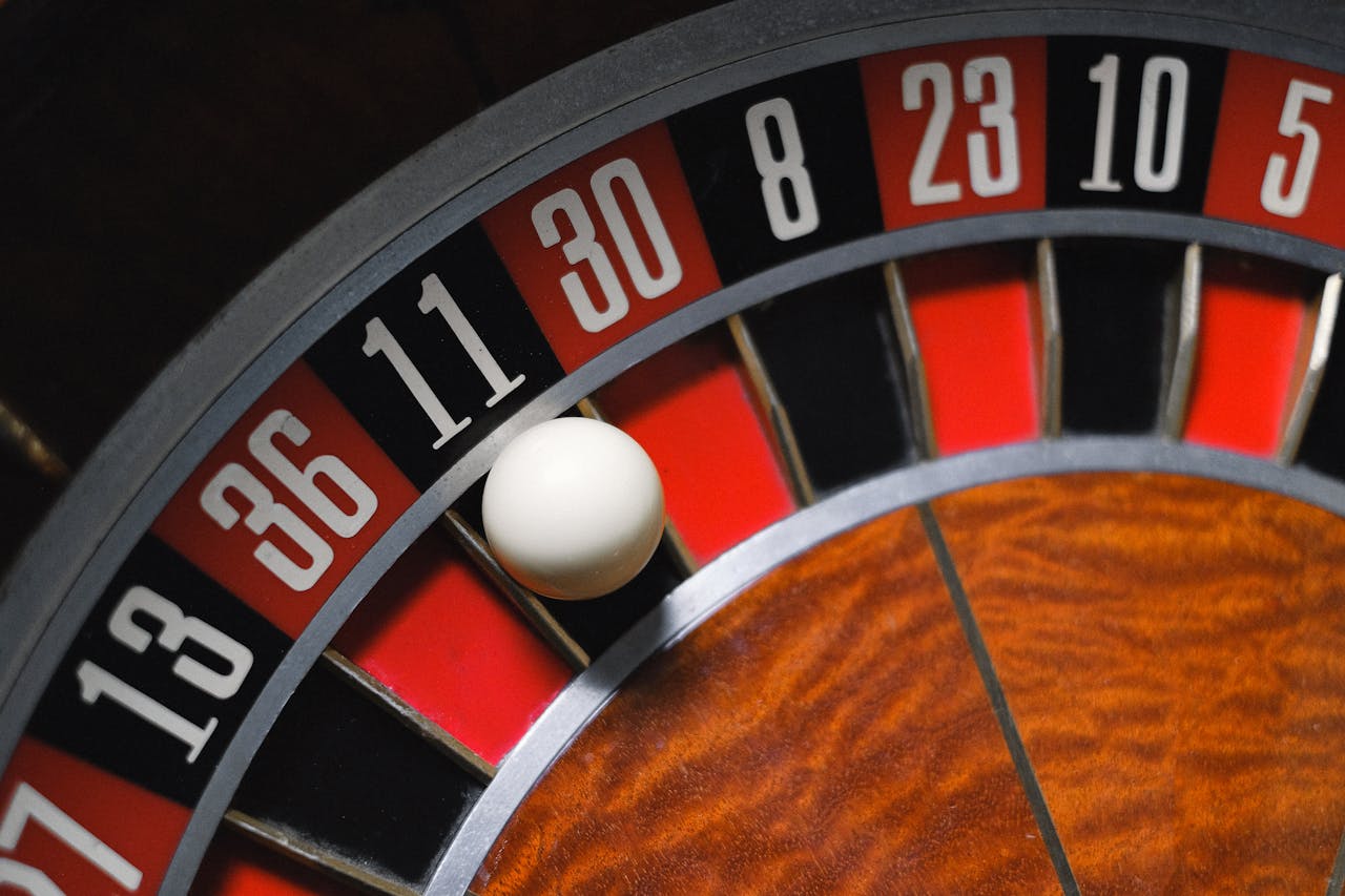Detailed view of a roulette wheel with a ball, emphasizing the excitement of gambling.